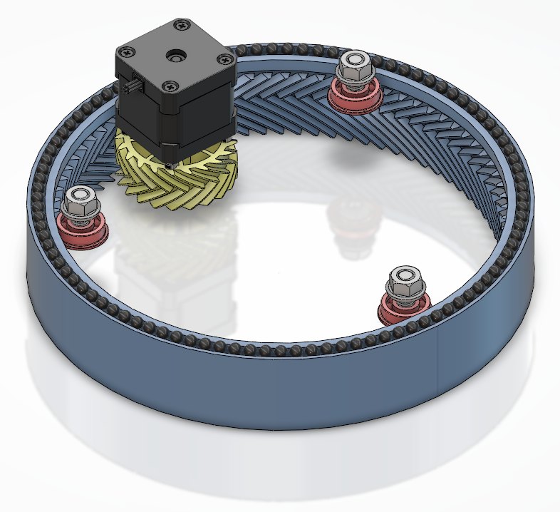 Rotating base with the top plate hidden, showing the pinion meshed with the internal herringbone ring gear and the ball race around the rim