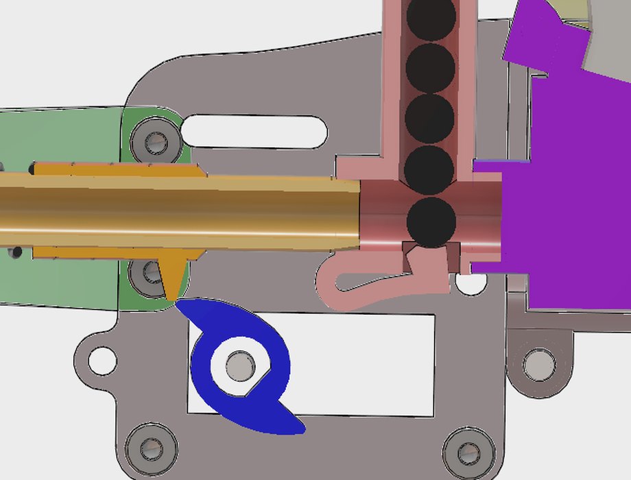 Section with the cam at full lift: the barrel is held clear and a ball has dropped to bore height